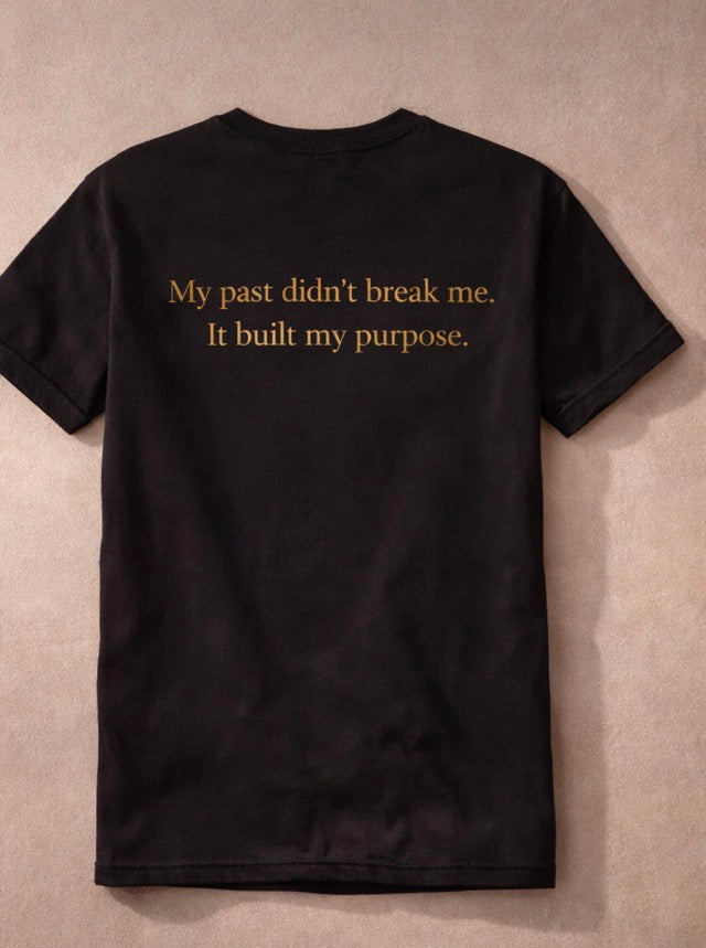 Black t-shirt with gold text on a beige background